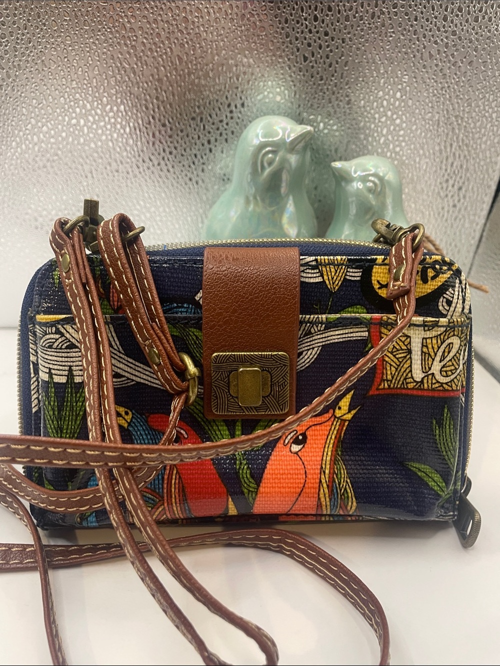 Sakroots Navy Crossbody Wallet with Multicolor Parrot Print and Brown Trim